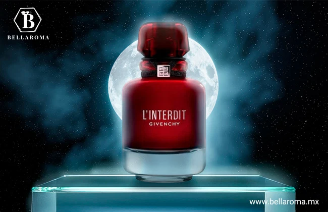 Frasco rojo intenso de L’Interdit Rouge de Givenchy con base transparente, presentado sobre una base de cristal iluminada.